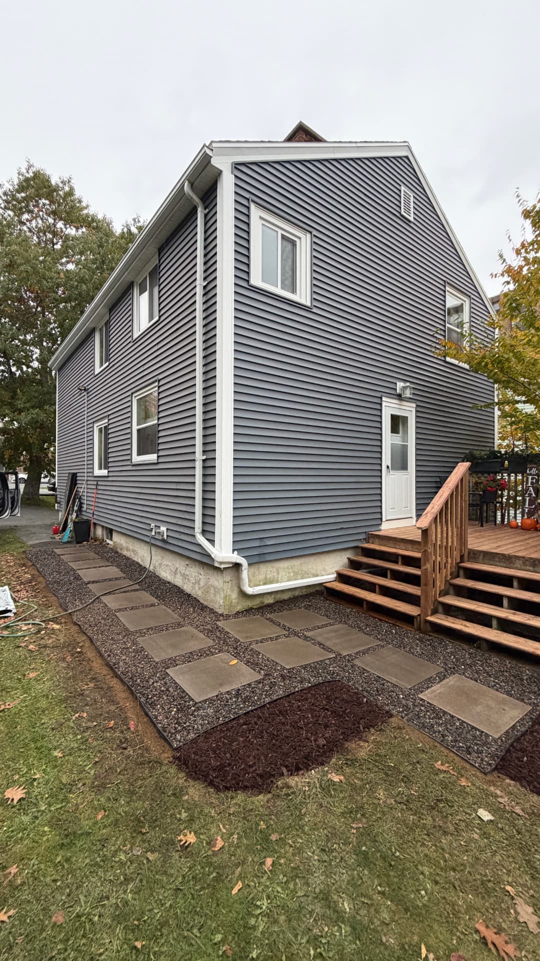 New paver stepping stones and gravel path along a home