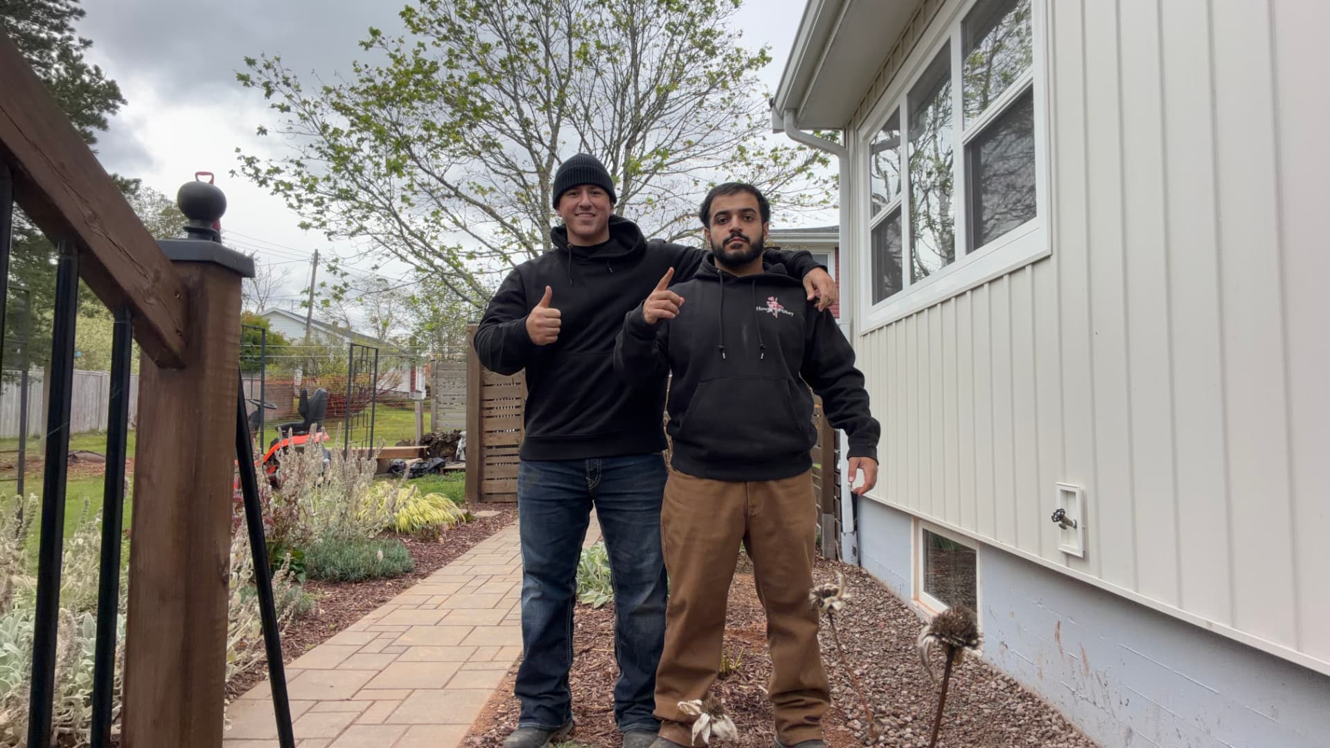 Kass and Dani giving a thumbs up after finishing a front yard refresh