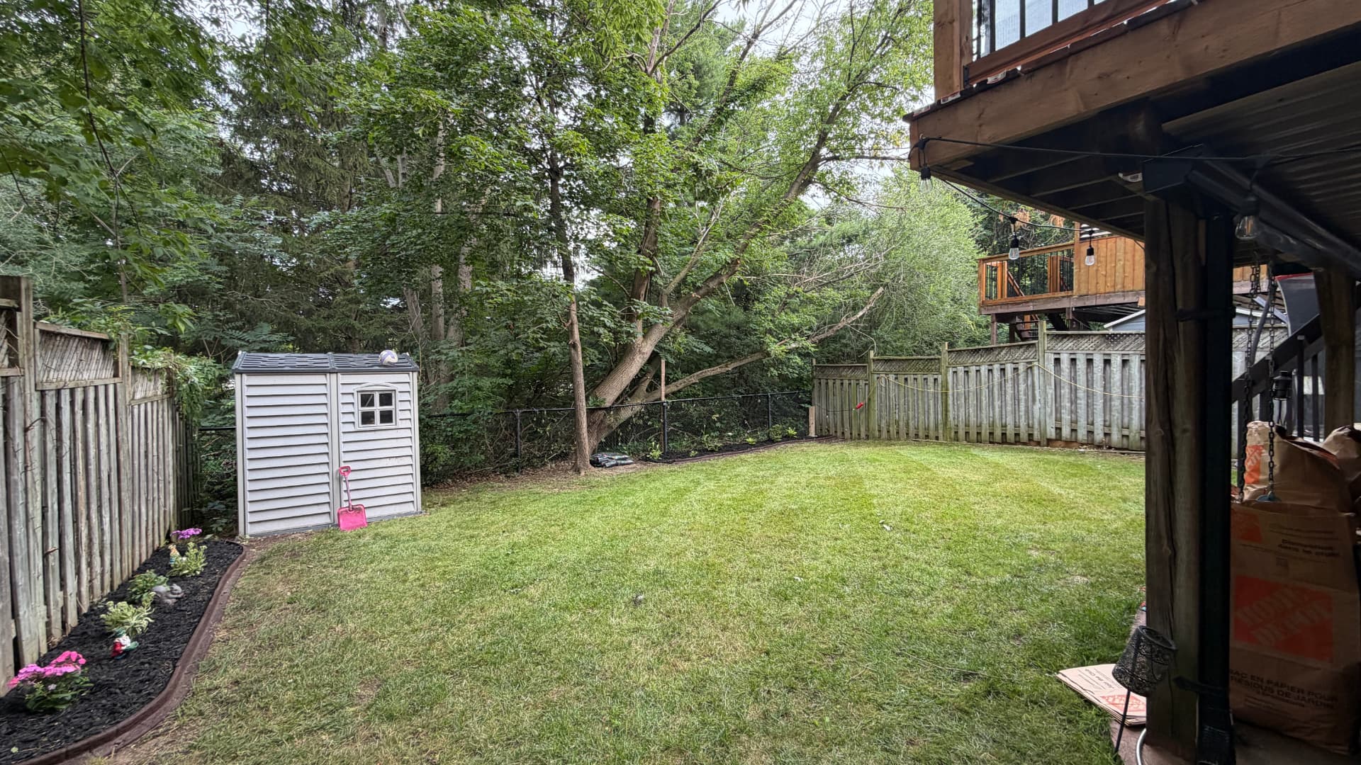 Neat back lawn with fresh mulch bed and tidy edges